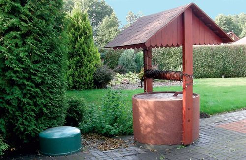 Pompa ciepła (zielona kopuła) jest częściowo zagłębiona w ziemi tuż obok dawnego ujęcia wody