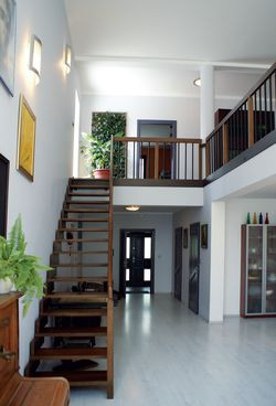 Na piętrze, po lewej stronie schodów, usytuowane są drzwi prowadzące na taras