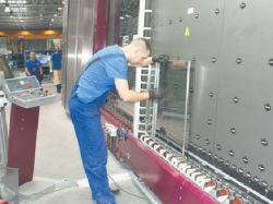 Zespalanie ramek z szybami. W czasie tego procesu przestrzeń między taflami jest wypełniana gazem szlachetnym.