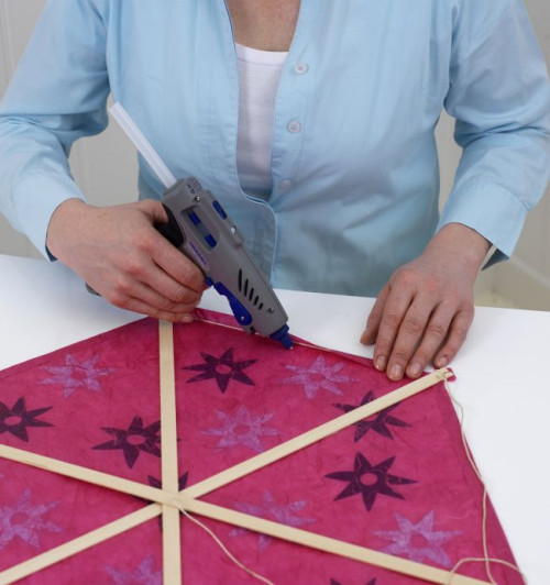 Użyj pistoletu do klejenia Dremel Glue Gun i kleju w sztyfcie, aby nałożyć pasek kleju po wewnętrznej stronie sznurka