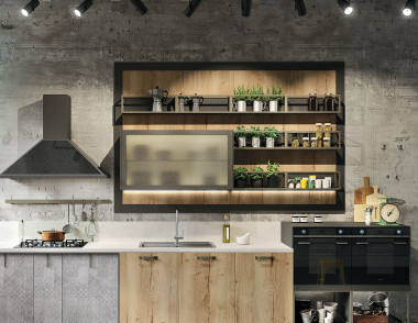 Surowa powierzchnia betonu podkreśla ciepło drewnianych frontów szafek z kolekcji Loft