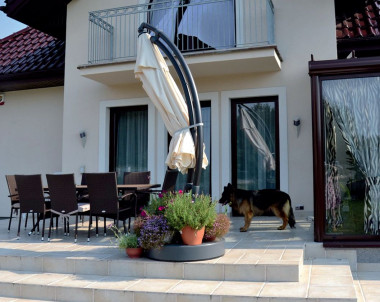 Na taras można wyjść z salonu oraz z ogrodu zimowego