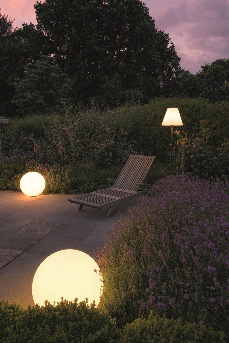 Niskie lampy w kształcie kul oświetlają taras