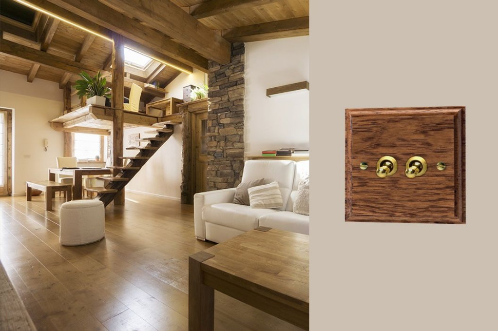 Nowoczesny osprzęt elektroinstalacyjny: złote przełączniki na drewnianej ramce