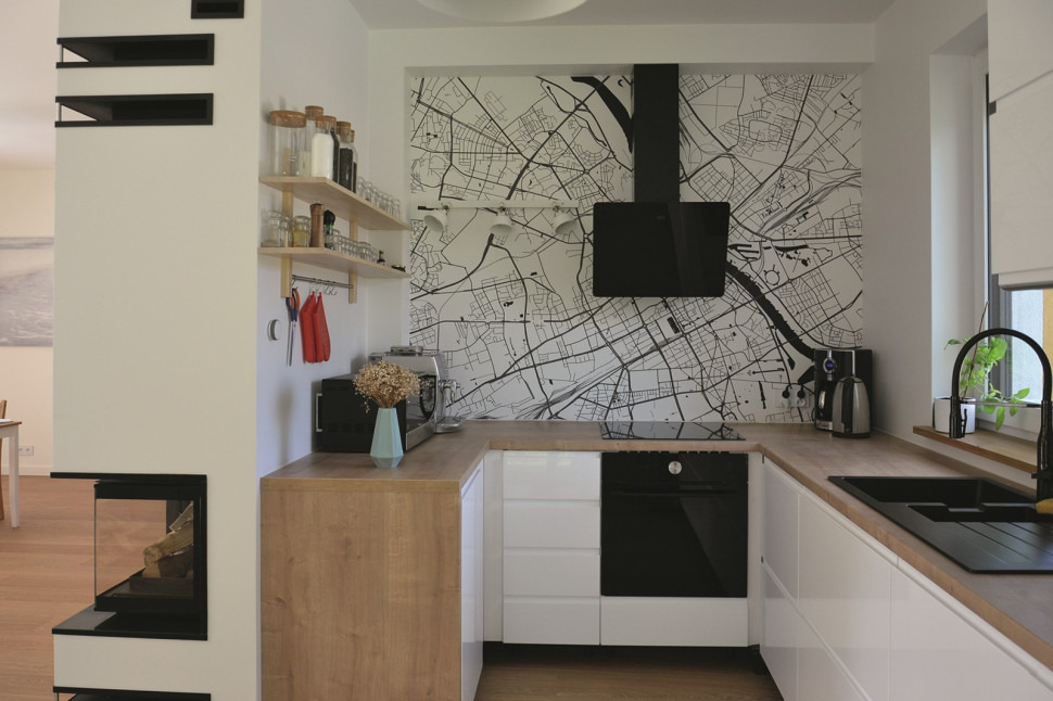 Ściana w kuchni ozdobiona biało-czarną fototapetą (z planem miasta)