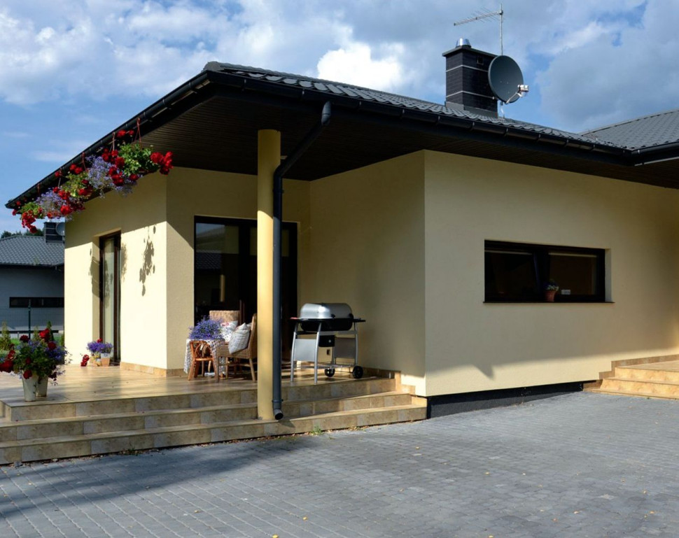 Niska parterowa bryła budynku jest prosta i uniwersalna. Ma kształt litery L.