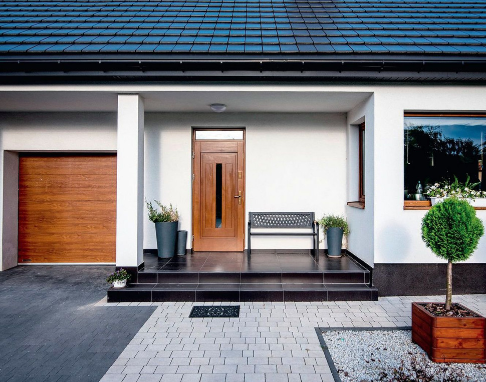 Główne wejście do budynku, we wnęce pod stropem parteru, zamykają drewniane drzwi z szybą pośrodku i z górnym szklanym doświetlem