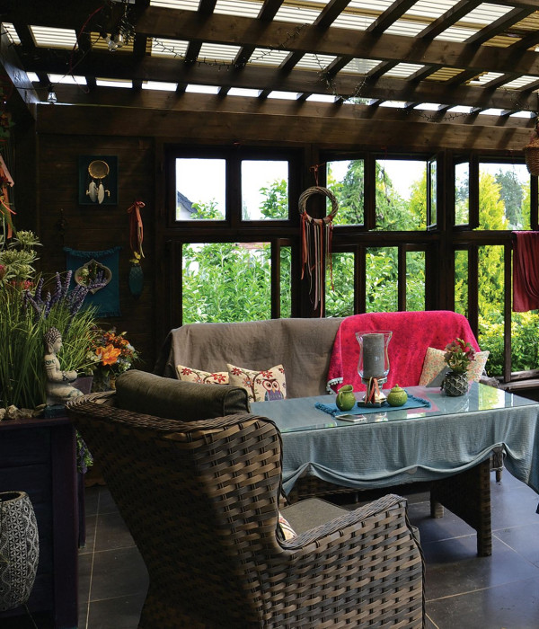 Do wykończenia dachu właściciele wykorzystali przydymione trapezowe płyty z poliwęglanu, natomiast boczne ściany drewnianej konstrukcji wypełnili oknami skrzynkowymi, ze starego dworku