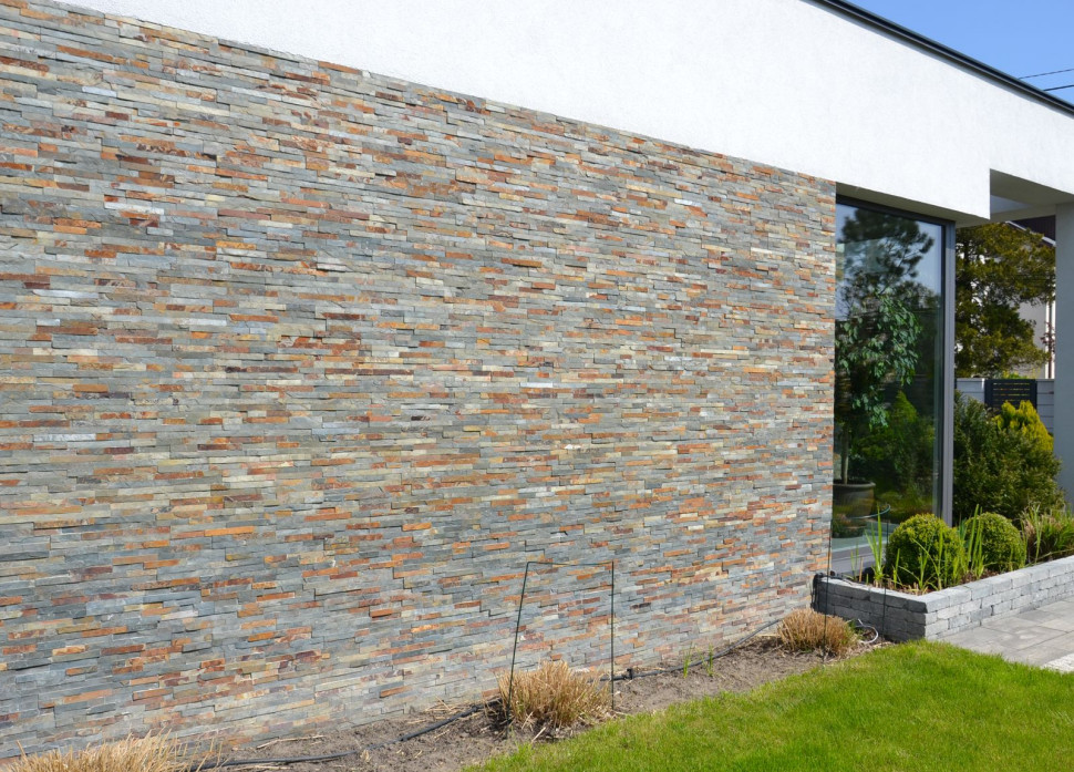 Okładzina w odcieniach szarości i rudości pasuje do ram okien