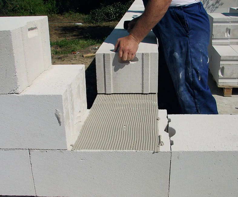 Ściany z betonu komórkowego stawia się, używając cienkowarstwowej zaprawy klejowej.