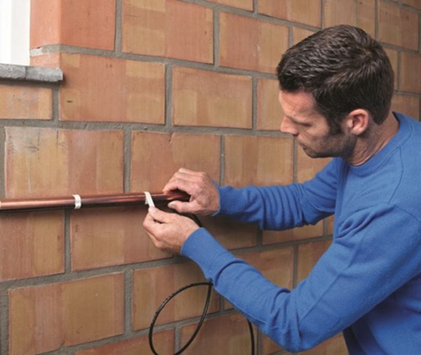 Przewód grzejny jest mocowany równolegle na rurociągu