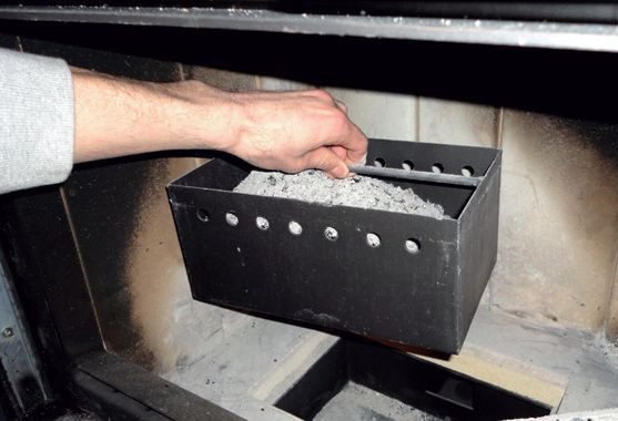 Popielnik umieszczony w centralnej części wkładu kominkowego